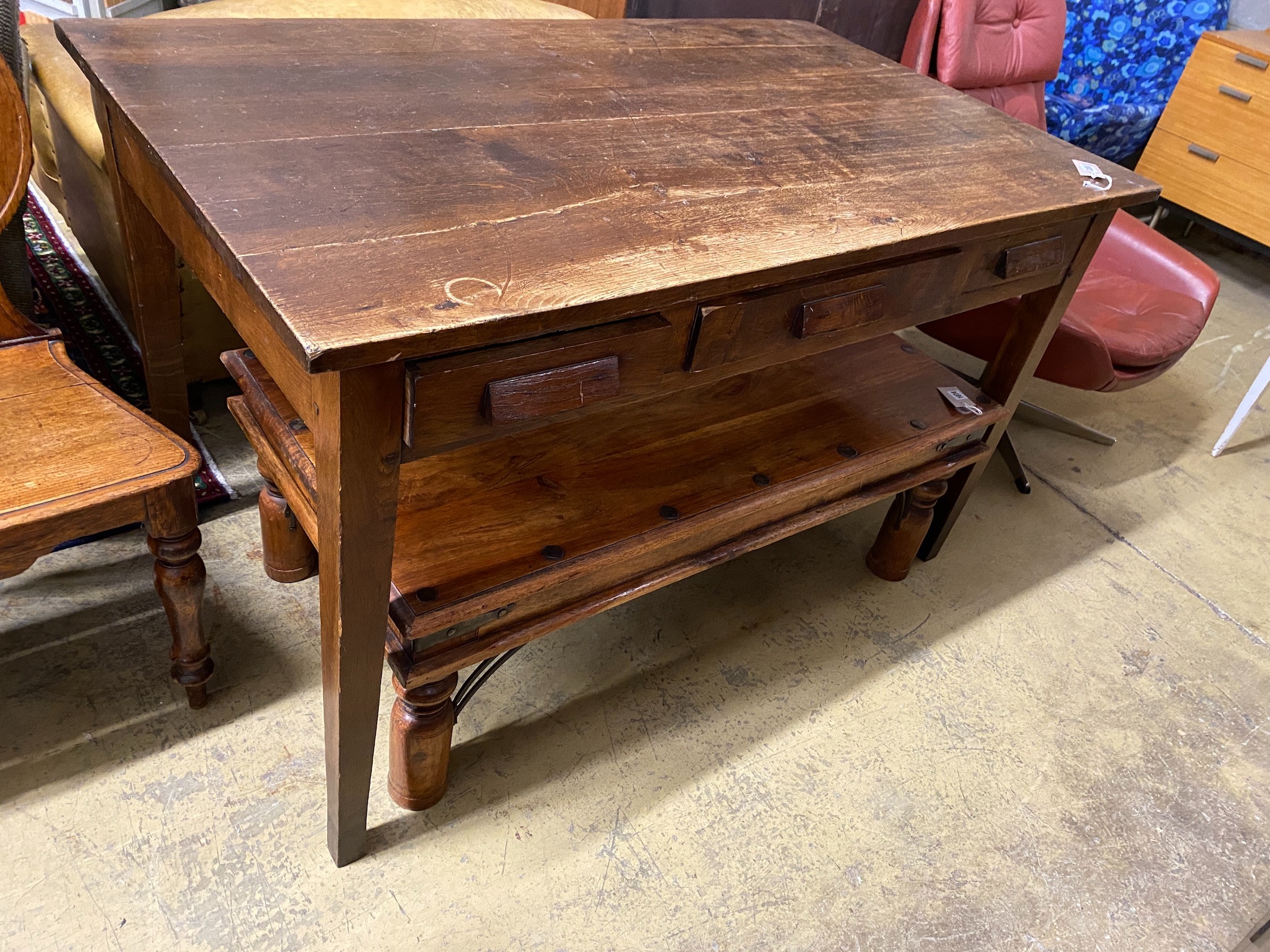A mid century oak writing table with planked top and three drawers, length 130cm, depth 78cm, height 78cm